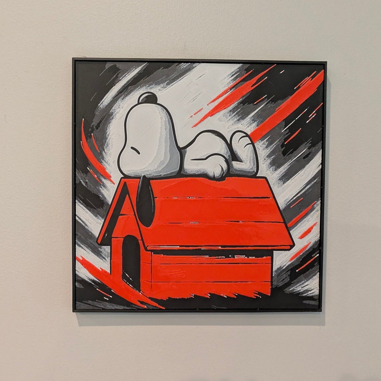 Framed artwork of a doghouse with a dog inside on a beige wall.